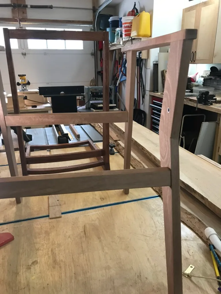 Assembled mahogany chair frame, before the parachute cord seat was woven, standing in the garage