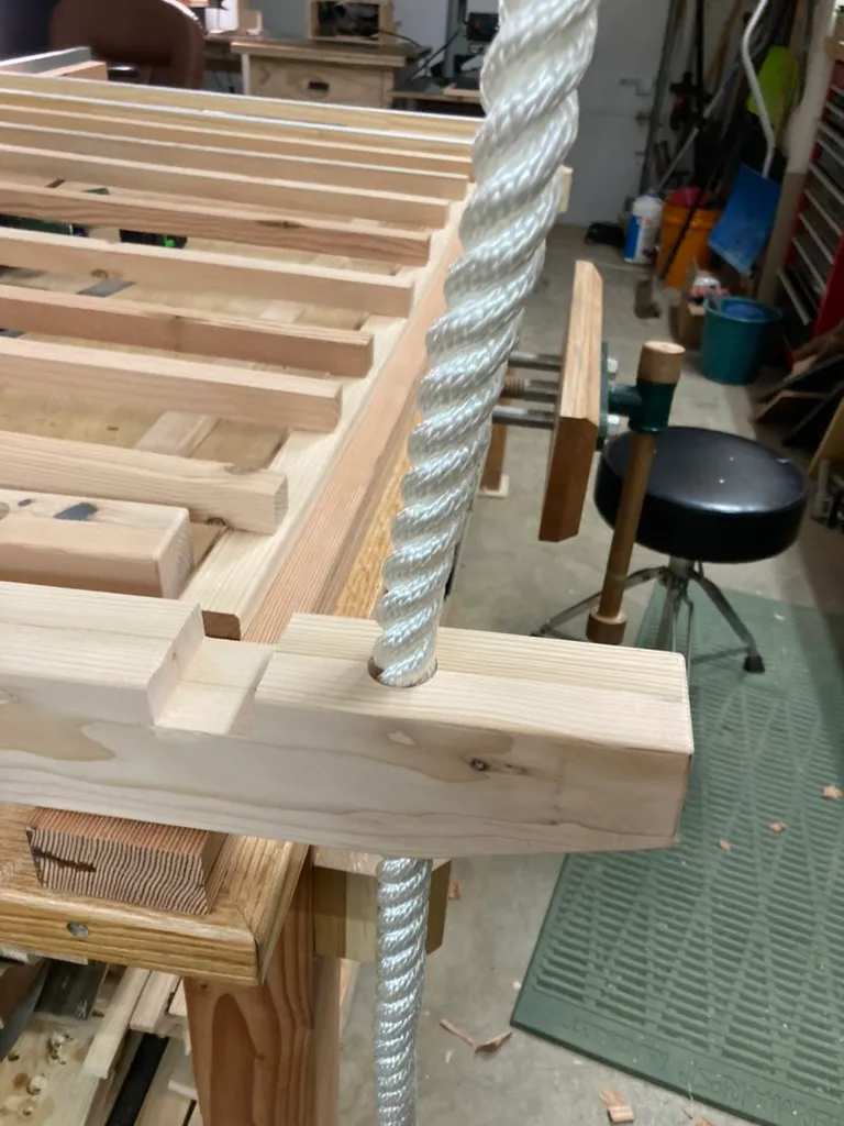 Drilling the porch swing frame for the rope suspension