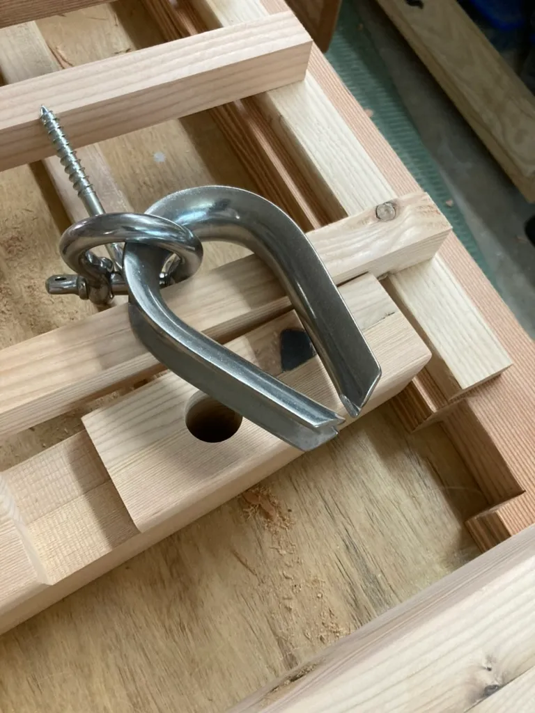 Stainless steel eye splice and clevis hardware detail on the porch swing's suspension rope