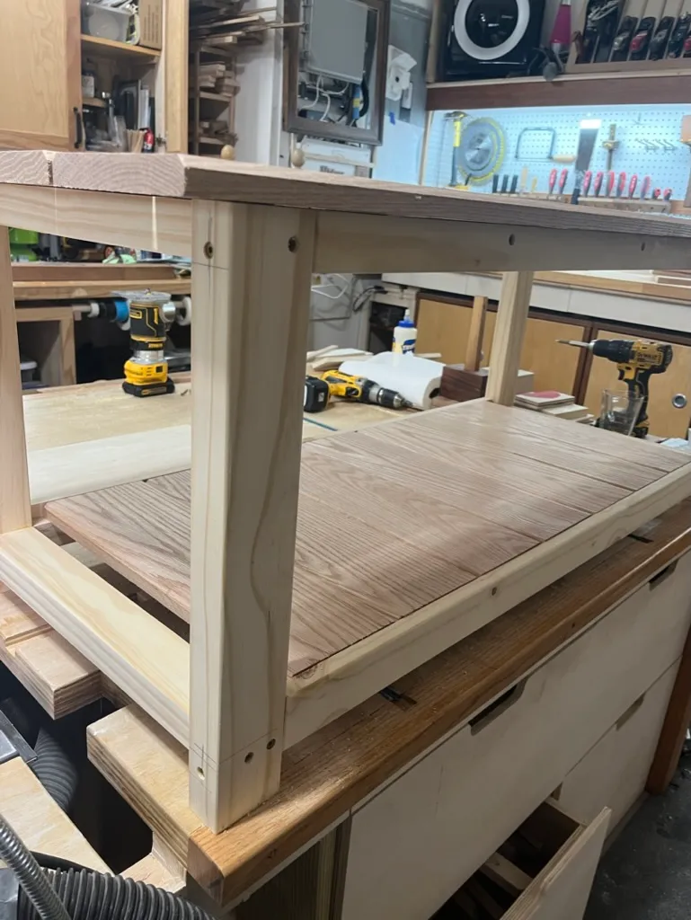 Fitting the coffee table's shelf into the white-painted frame