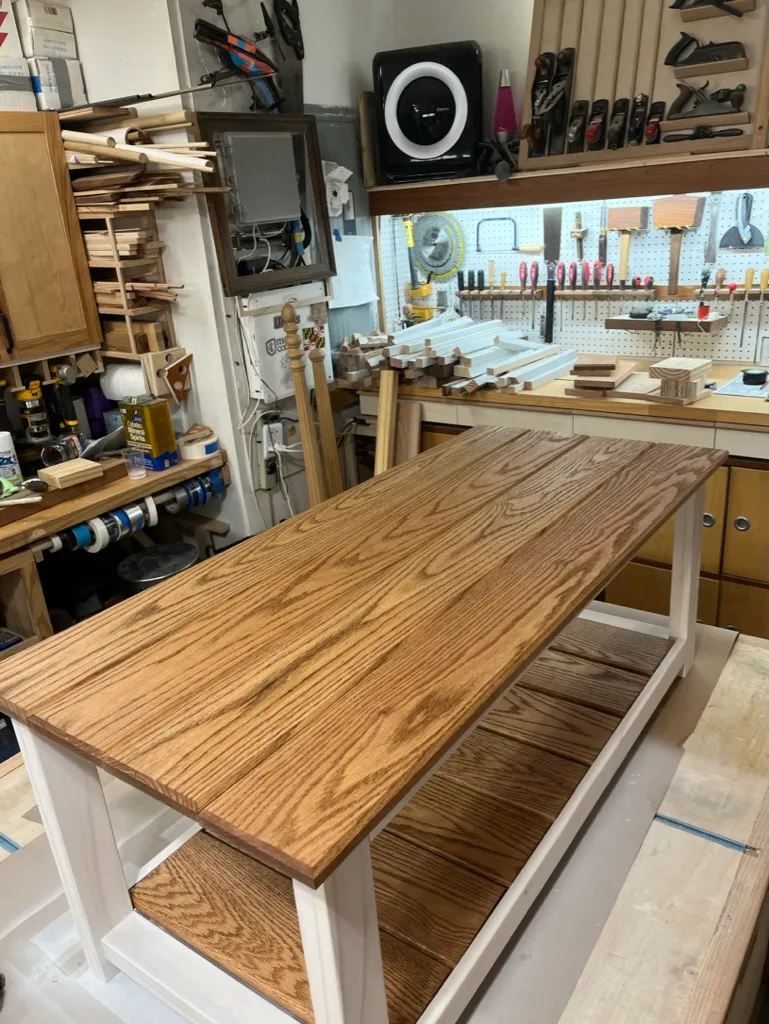 Fitting the final shelf slat on the coffee table