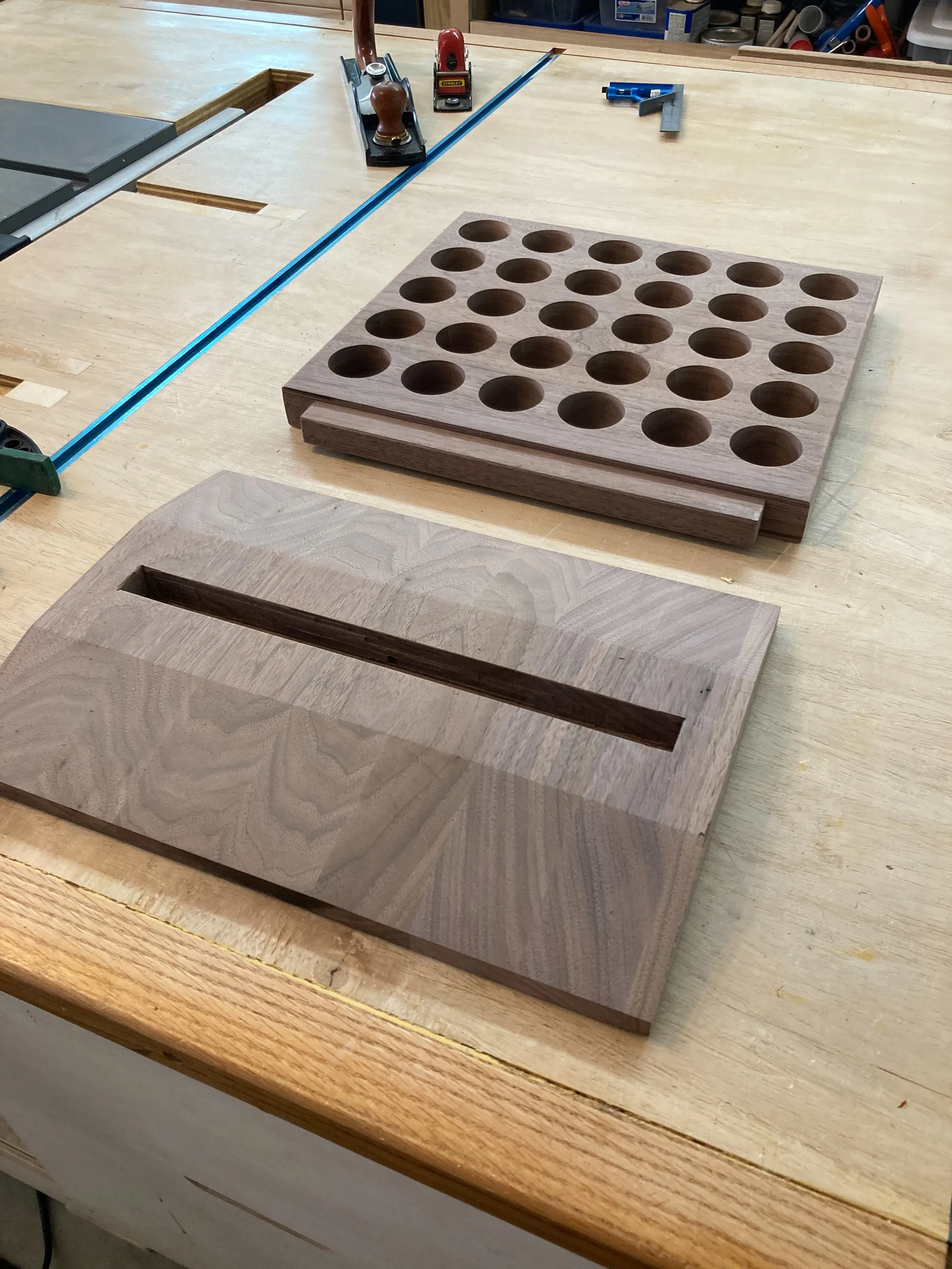 Finished walnut spice rack piece with a can of Watco Danish Oil, being hand-finished on a shop towel
