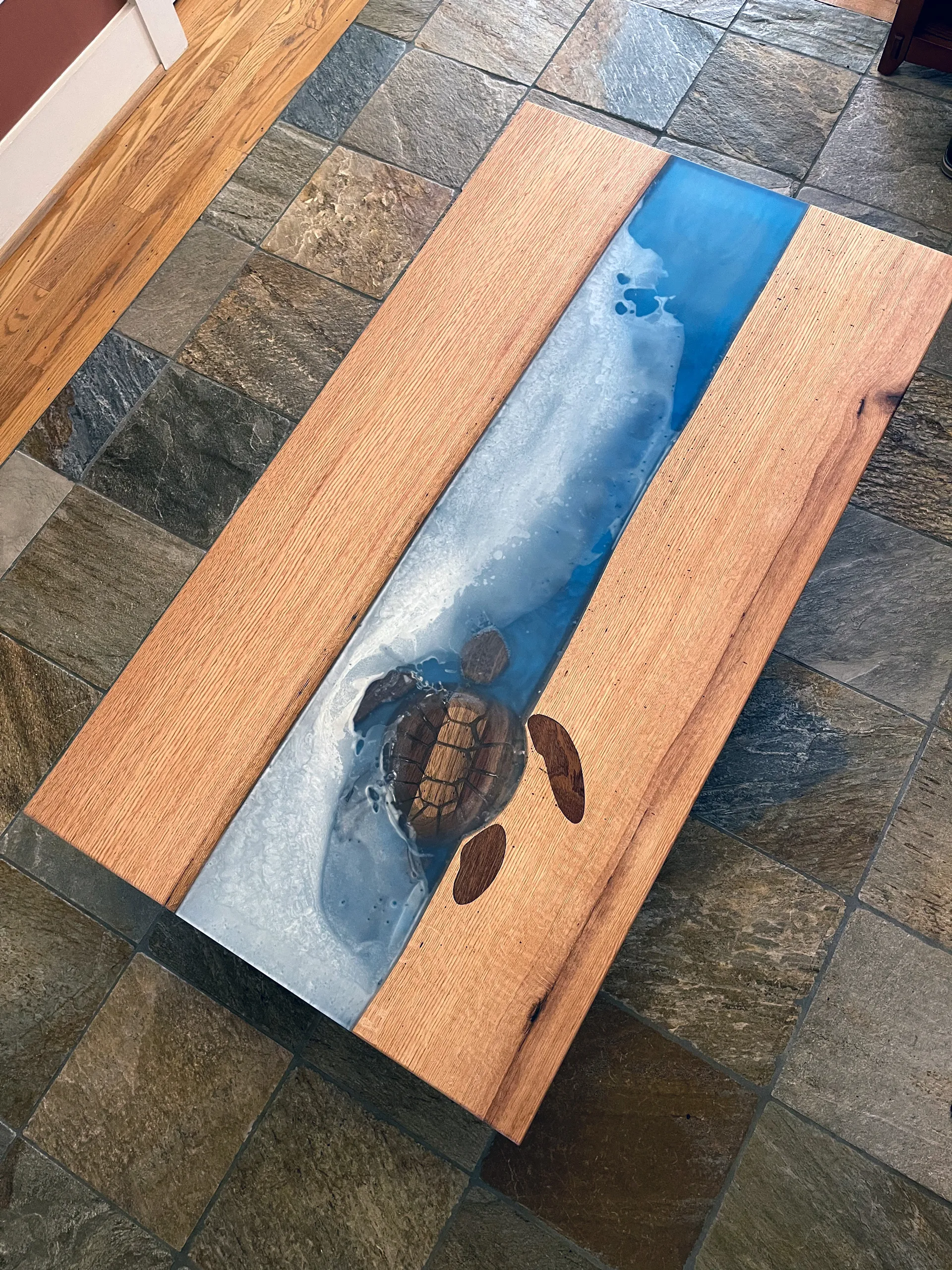 Sea turtle coffee table's epoxy river detail