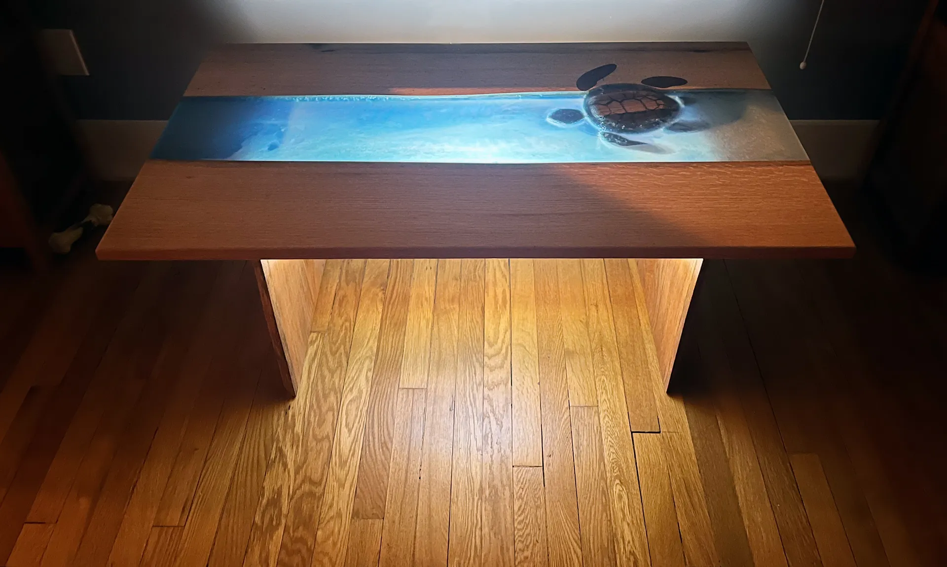 Sea turtle coffee table glowing from its hidden uplight at night