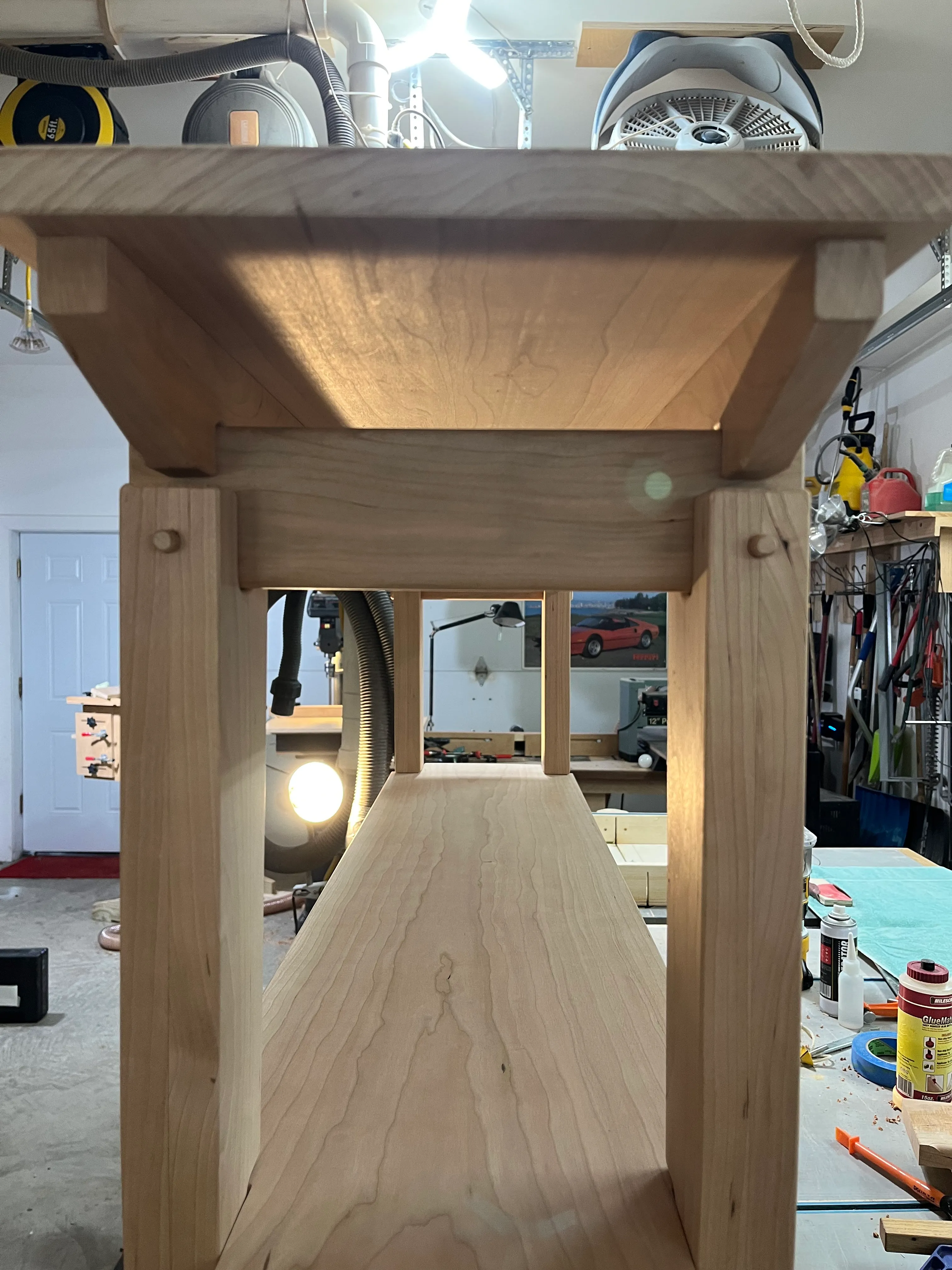 Looking through the end table's underside at the mortise and tenon corner joinery in the garage workshop
