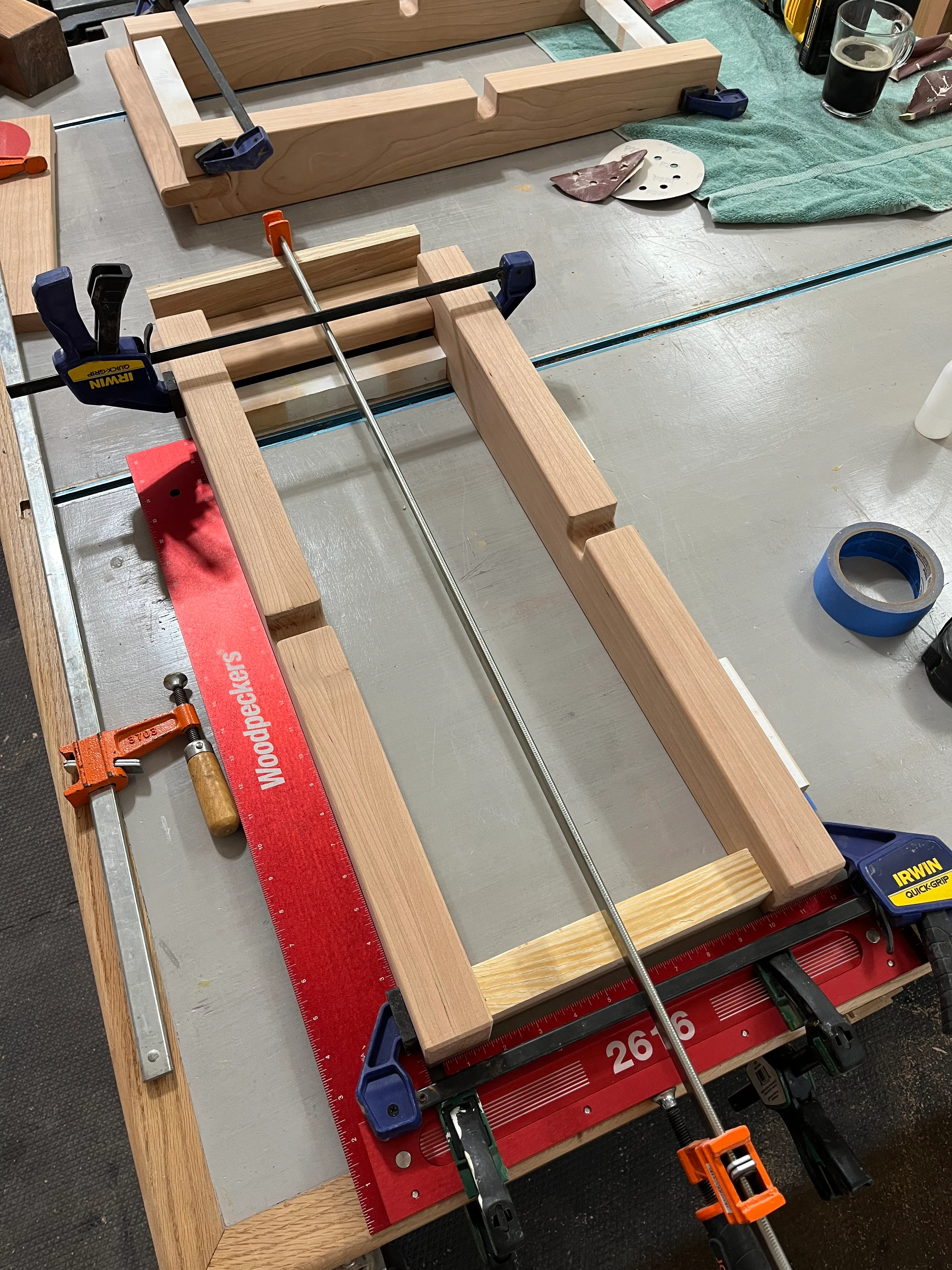 Cherry and pine end table joinery pieces clamped together with Jorgensen and Irwin bar clamps during glue-up